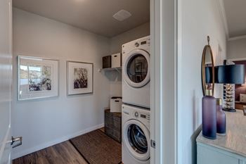 Lux apartments bellevue wa laundry room with front loading washer and dryer included and some added storage space.